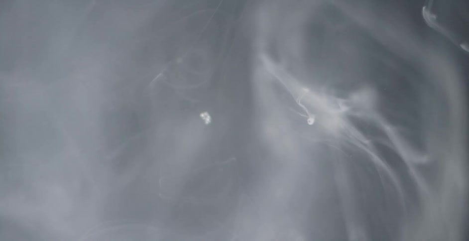 Bubbles float upward in murky water