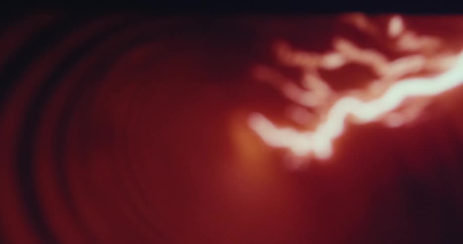 Red lightning moving through a portal in the sky at night