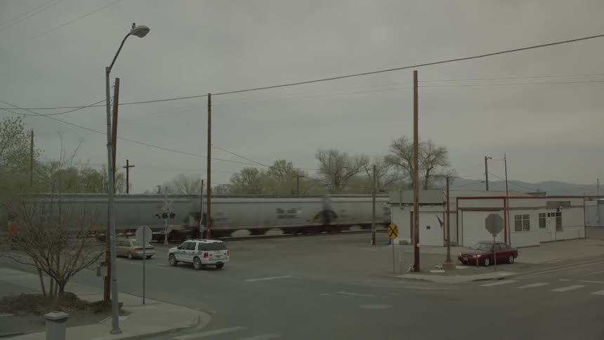 A train passes by stopped traffic
