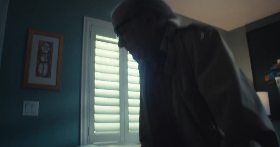 A man uses a walker to get to the door