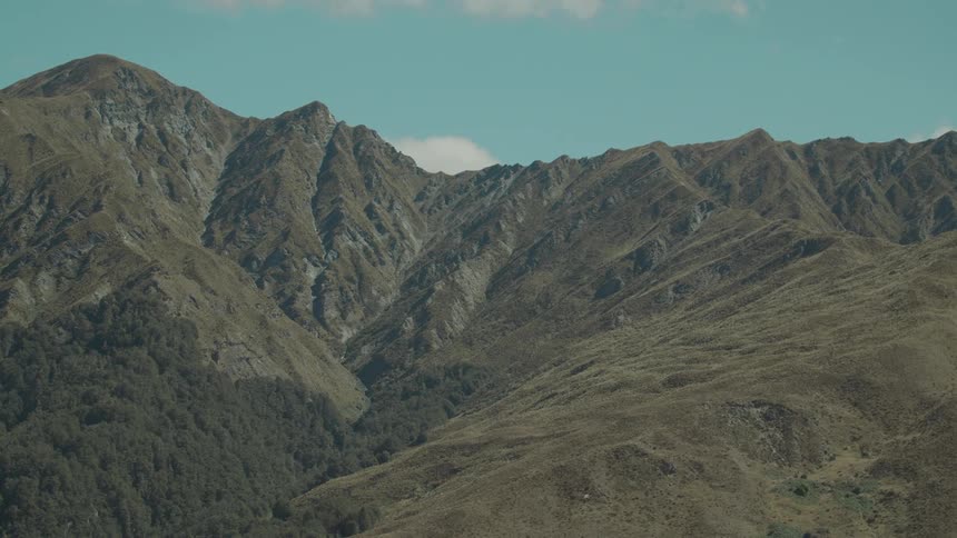 A scenic landscape of mountains under clear sky