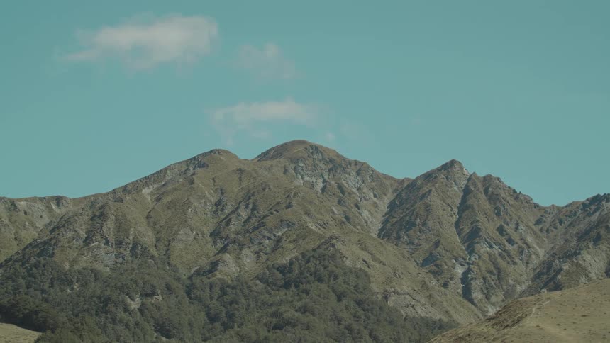 A large mountain is under the clear sky
