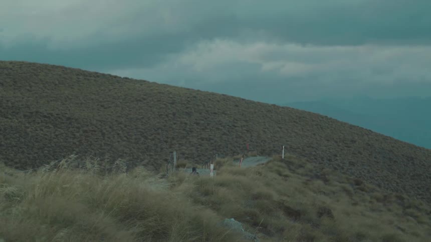A person is hiking up the tall hill