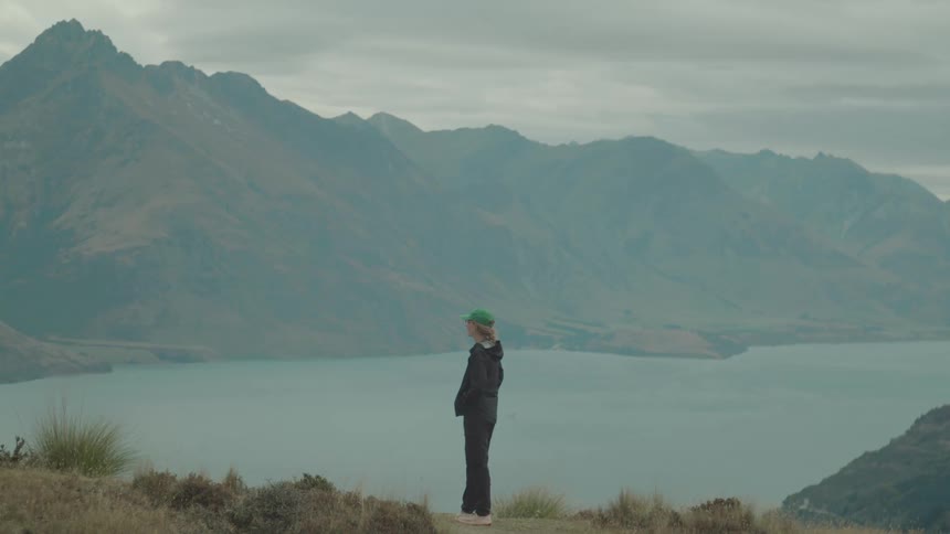 Woman on a mountain with a lake in the background
