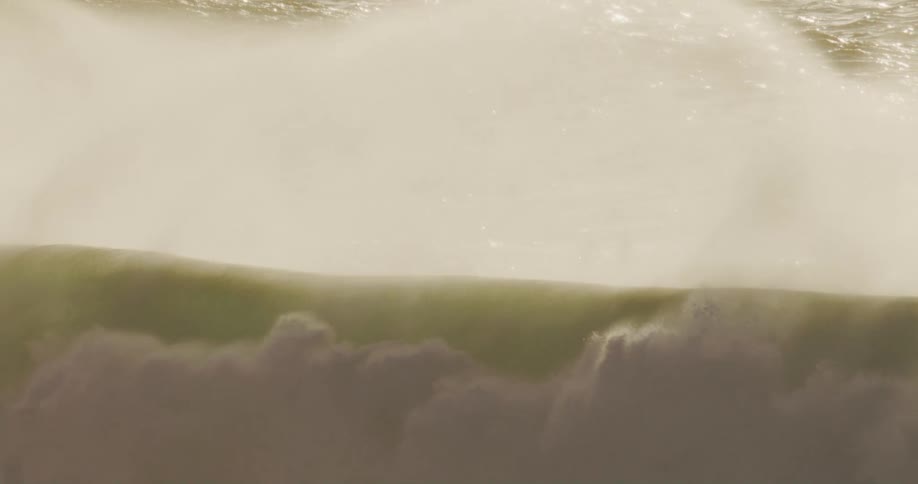 The wave crashes and splashes all over