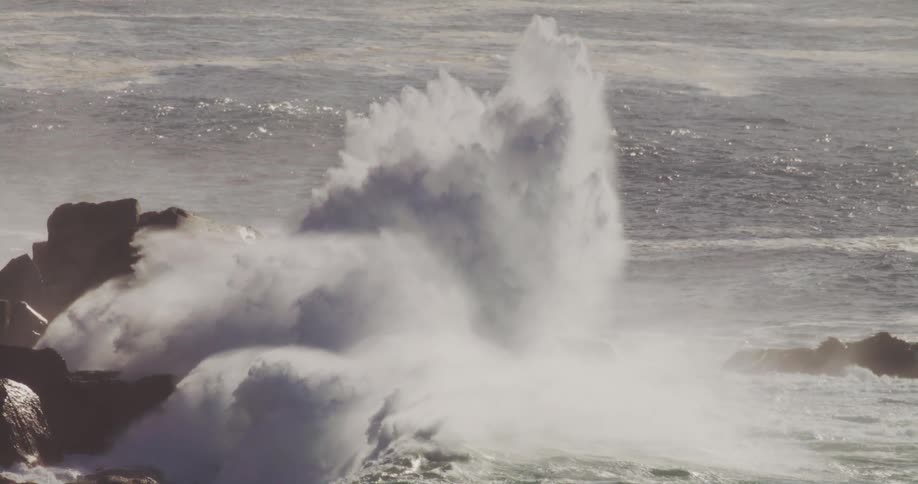 A wave crashes along the rocks