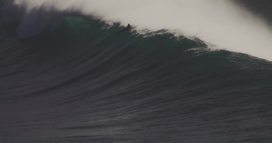 Some surfers ride a large wave