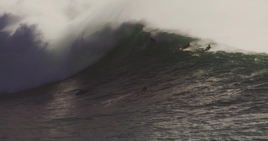 Some surfers ride a large wave
