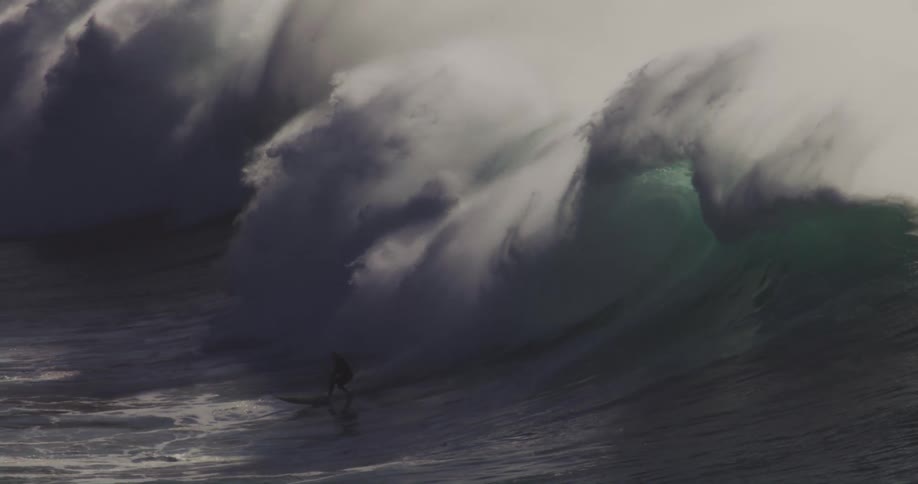 A person surfing a huge wave