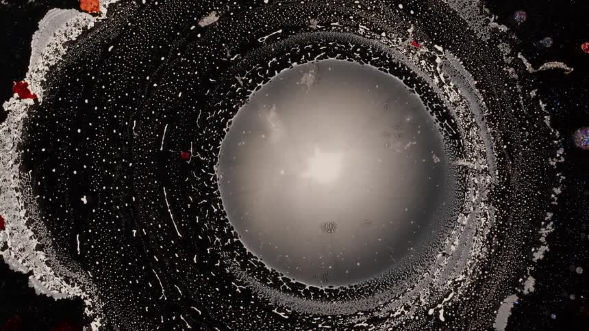 Abstract whitish liquid matter succumbing