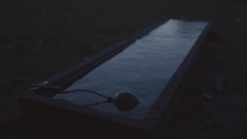 A container is full of water in the dirt