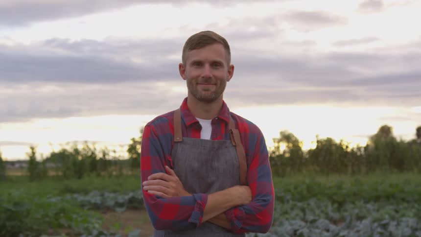 A man stands among his crops