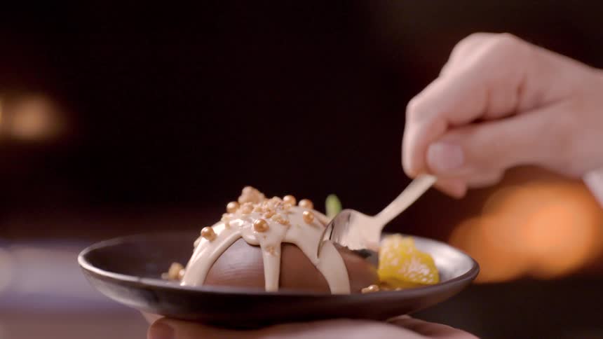 A person is eating a dessert