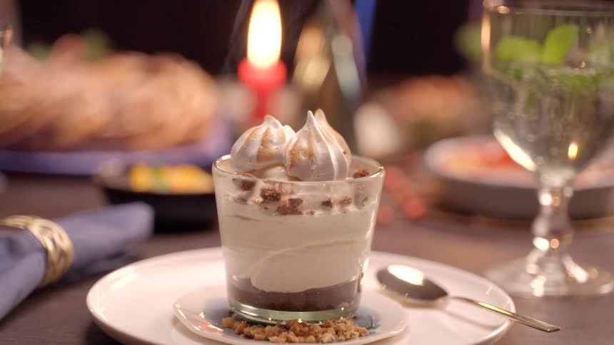 A dessert is being toasted with a torch