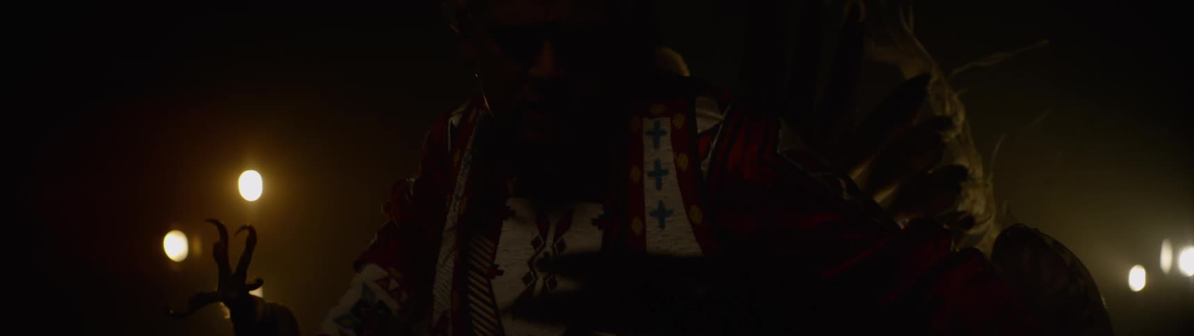 A native american man wearing indigenous clothing