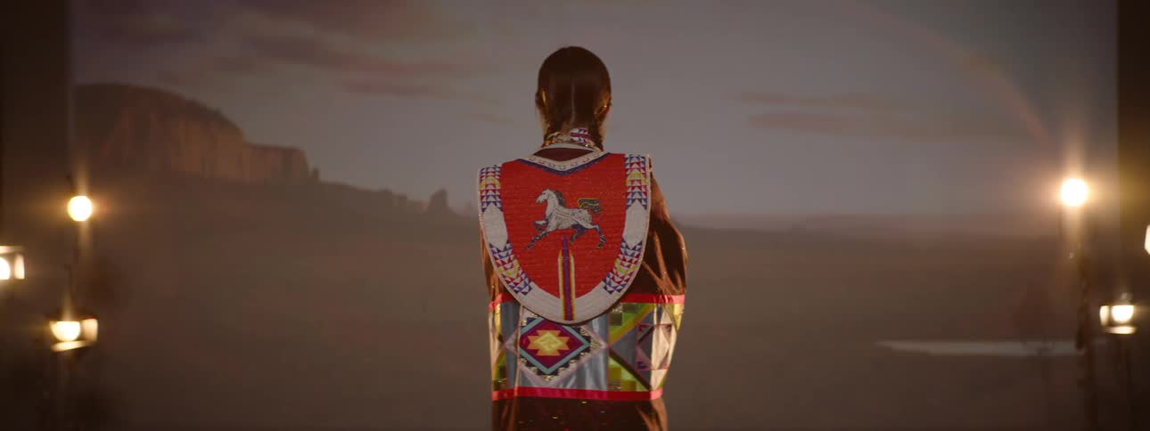 Young woman performing in traditional indigenous clothing