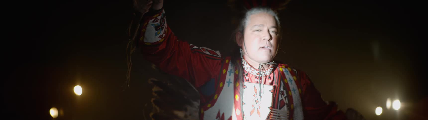 A man is dancing while wearing a costume