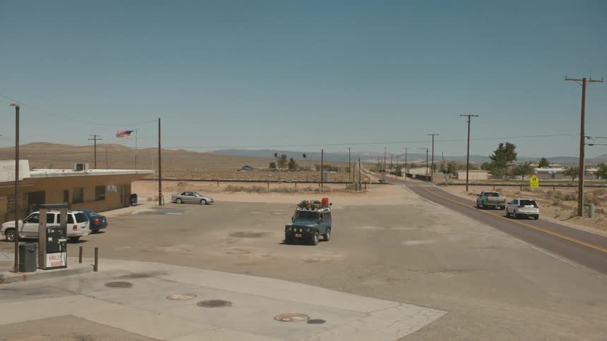 A jeep pulls into a gas station