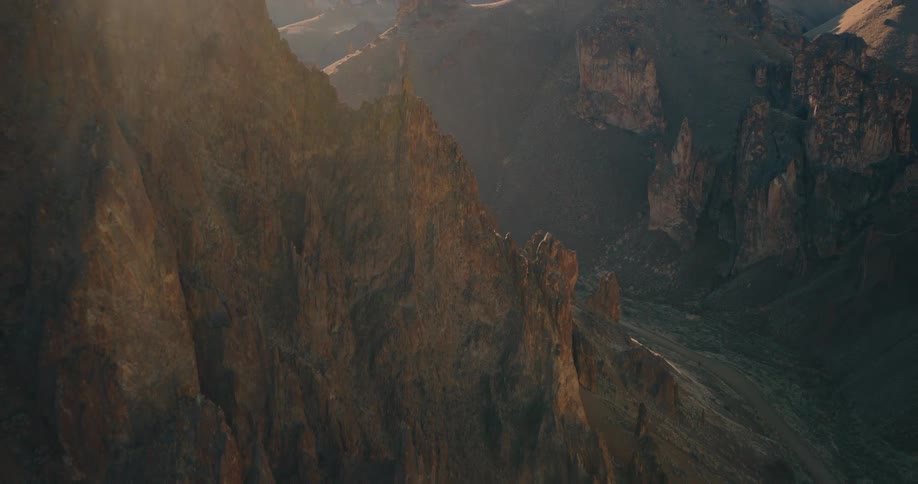 Aerial view of a highway in the middle of canyons and mountains