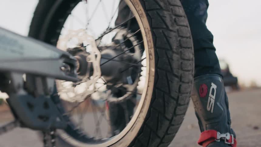 A motocross driver remotes the tire from his dirt bike