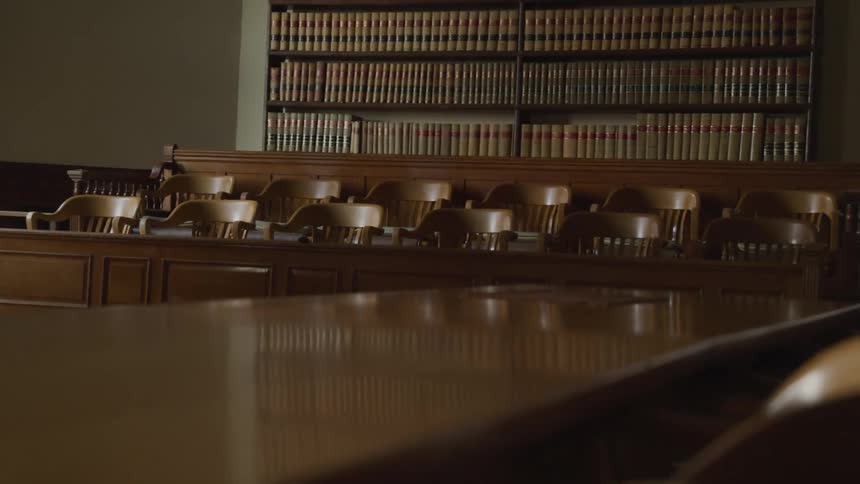 A library with long tables and many chairs