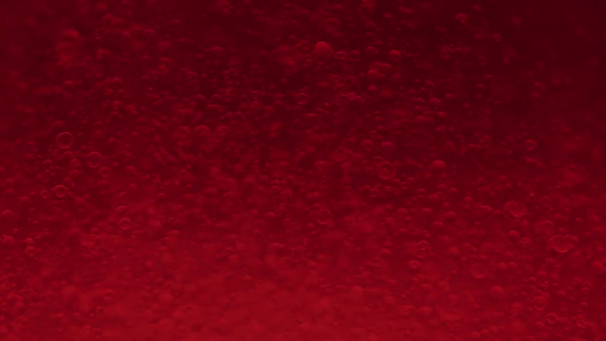 Red liquid with moving bubbles