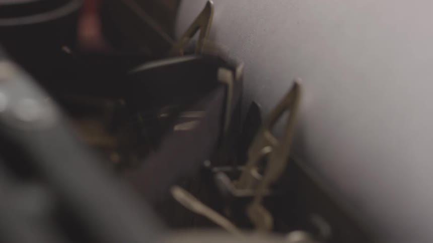 The typewriter is working on the paper