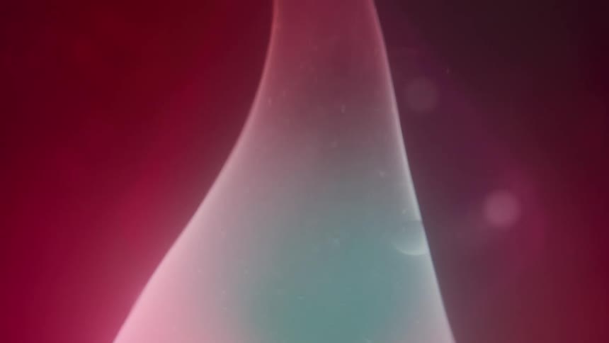 A white glowing bubble floats on thick blurred pink red liquid
