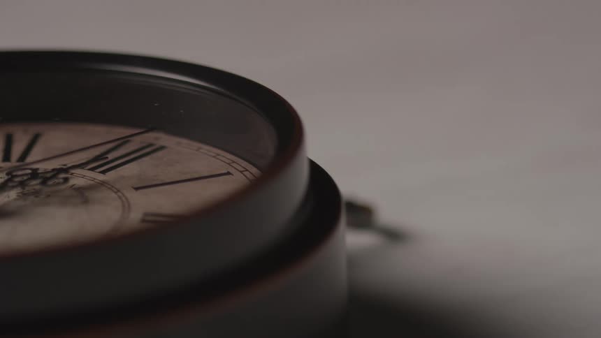 A brown clock ticks away