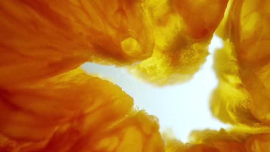 Extreme close up of an orange slice against a white background