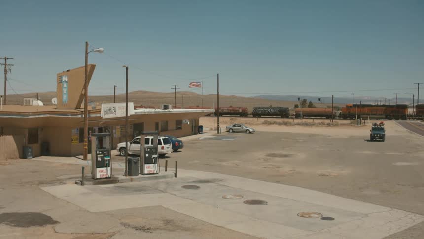 Train passes by a remote gas station