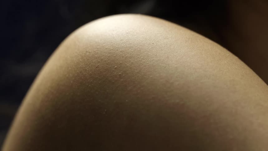 Closeup of a shirtless persons shoulder