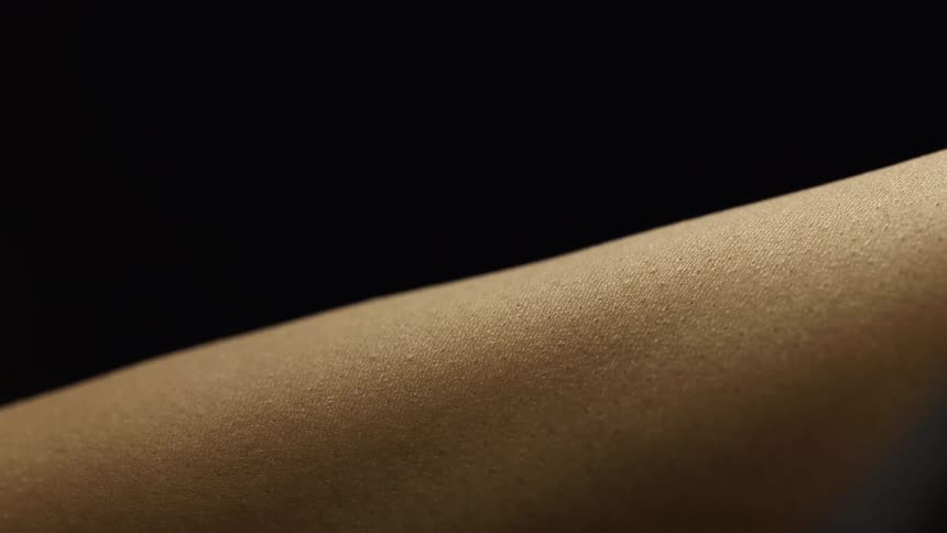 Goosebumps on a persons arm showing raised hair follicles and textured skin