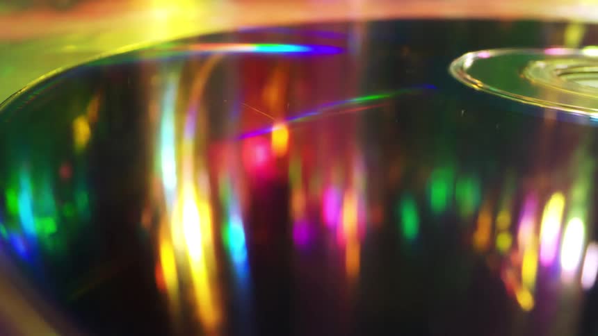 Closeup perspective of holographic light reflecting off a compact disc