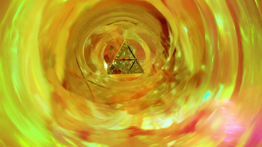 A glowing golden vortex with a triangular gemlike structure at its center