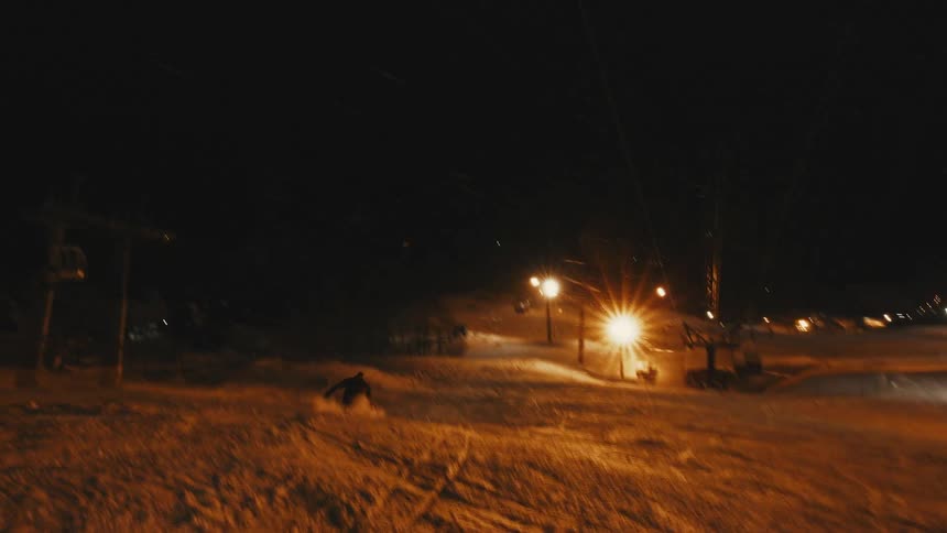 A snowboarder makes a jump during a snow storm