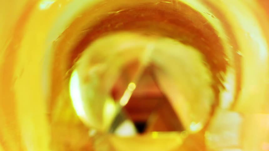 The inside of a golden yellow colored container with some triangles at the end
