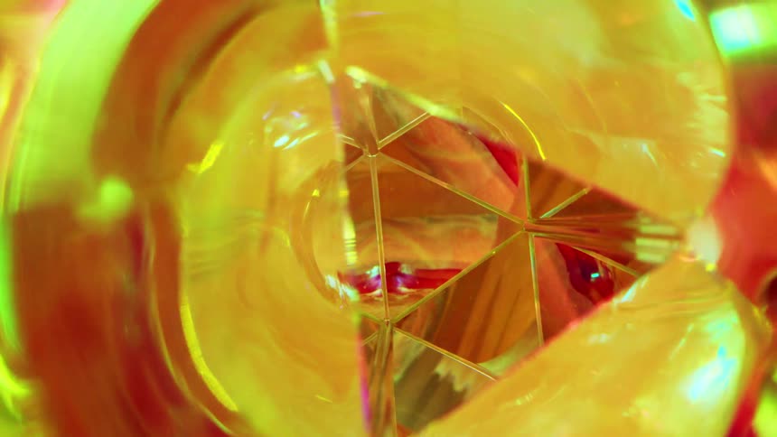 Abstract closeup of orange colored glass with reflections