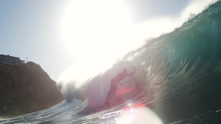 Man surfing a crystal clear tubular wave
