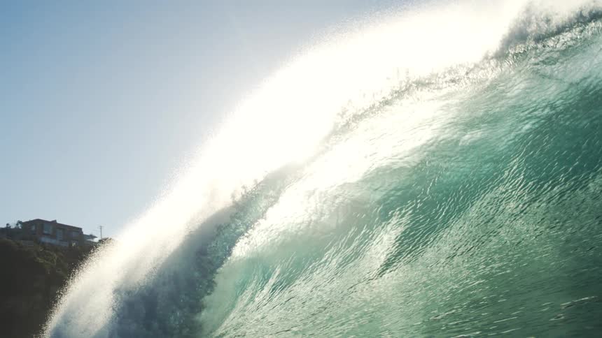 A large wave crashes over the camera