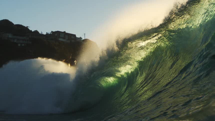 A very large wave hits the mountain on the shore
