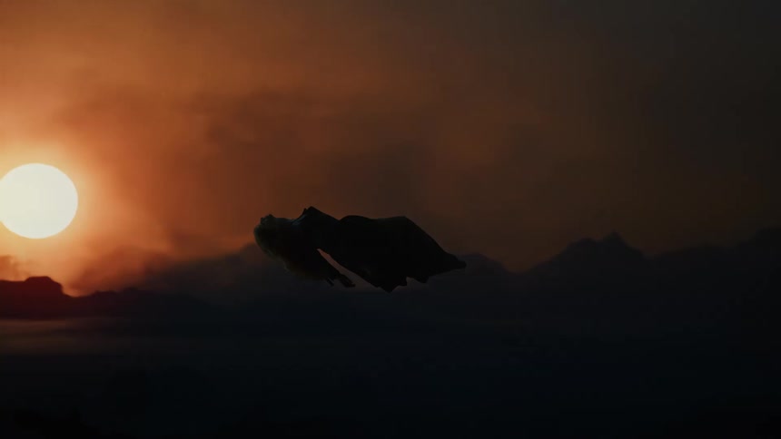 Silhouette of a woman floating among clouds with the sun on the horizon