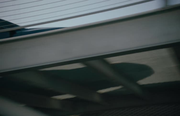 A car drives up the ramp in the outdoor parking garage