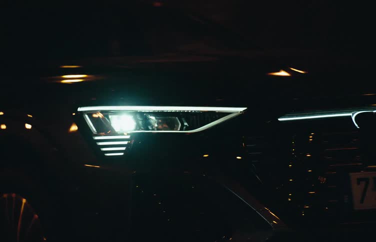 Front of an audi with led headlights on driving through the city