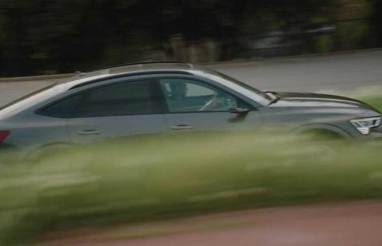 Man drives a car on a street in an urban area during the day