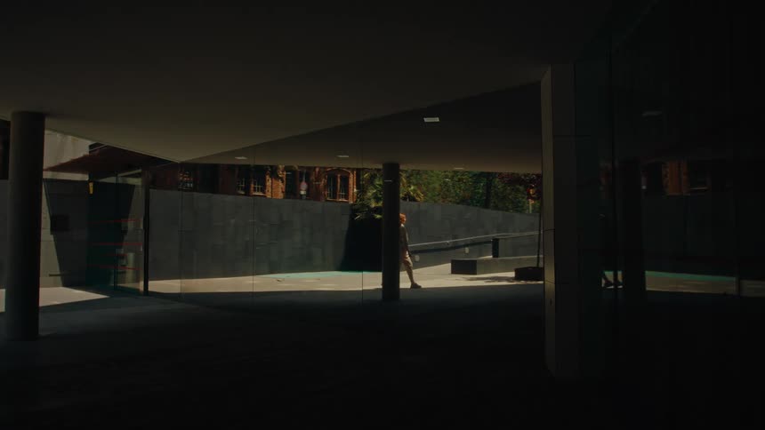 A woman walks towards the building