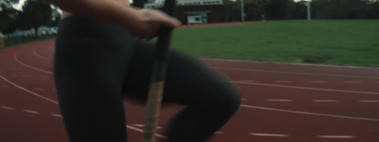 A woman runs as she practices on a track for pole vaulting