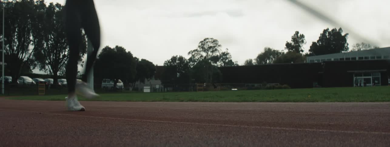 A woman is pole vaulting on the track