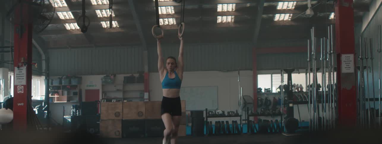A lady working out inside the gym at midday