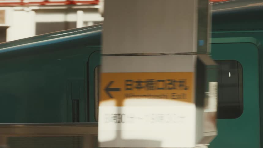 A jet train enters and stops at a train station where people are waiting to board at midday